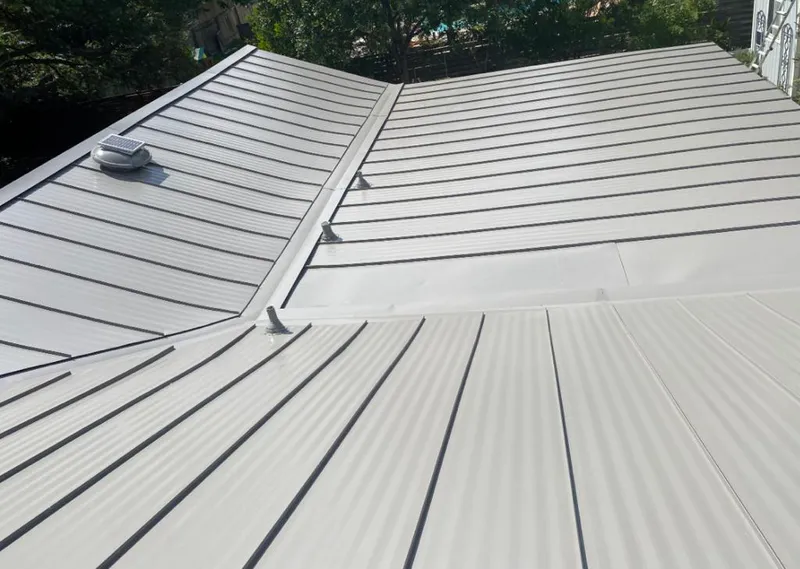 Solar attic fan installed on a metal roof for Roof Ventilation in Los Alamitos