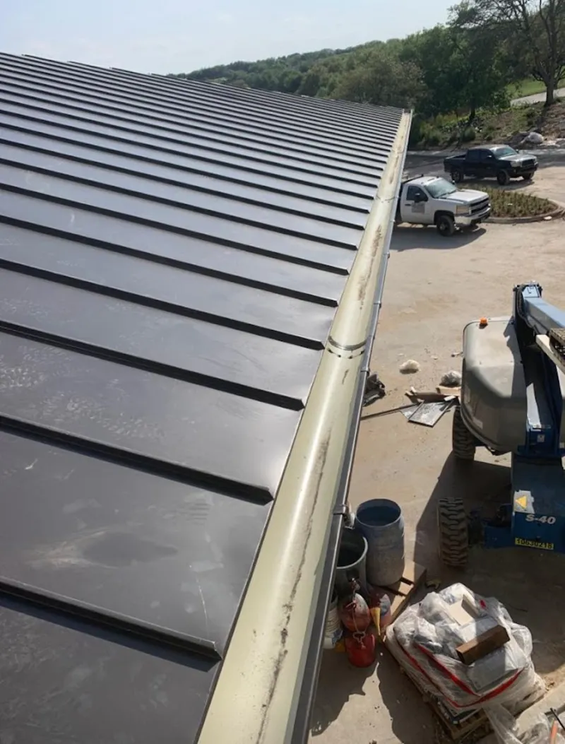 Standing seam panel and gutter detail on a metal roofing jobsite in Los Alamitos
